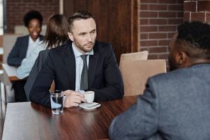 Two adults having a serious conversation over coffee in a cafe