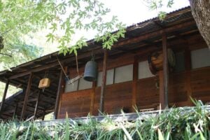 The wooden zendo at Tassajara Zen Mountain Center, with its bell, han and drum hanging under the eaves