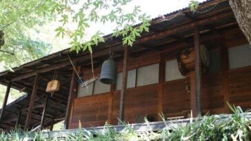 The wooden zendo at Tassajara Zen Mountain Center, with its bell, han and drum hanging under the eaves