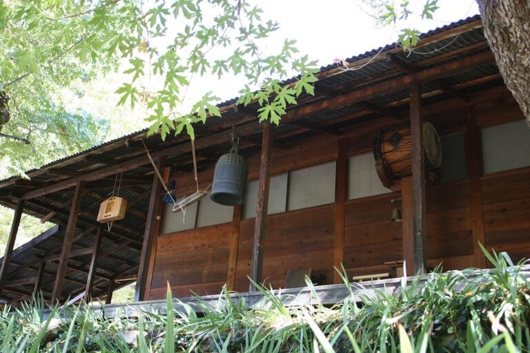 The wooden zendo at Tassajara Zen Mountain Center, with its bell, han and drum hanging under the eaves